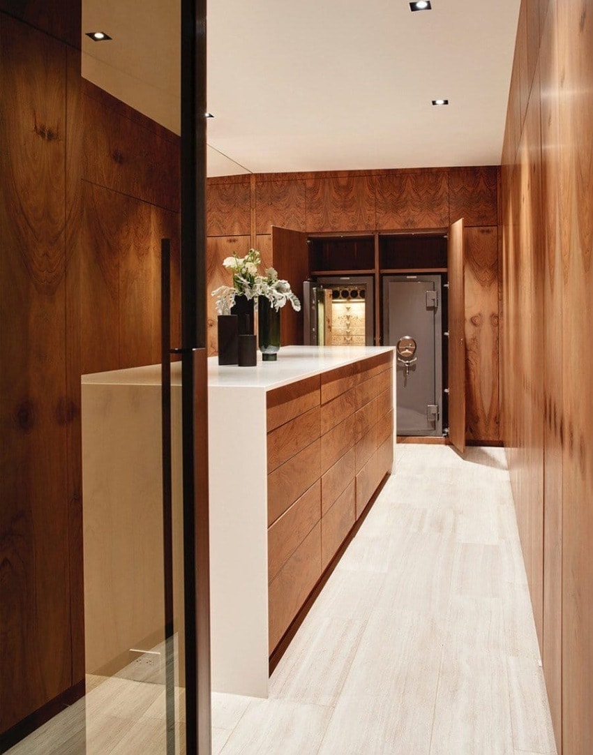 Modern kitchen with wooden cabinets, white countertop, recessed lighting, and elegant floral arrangement on the island.