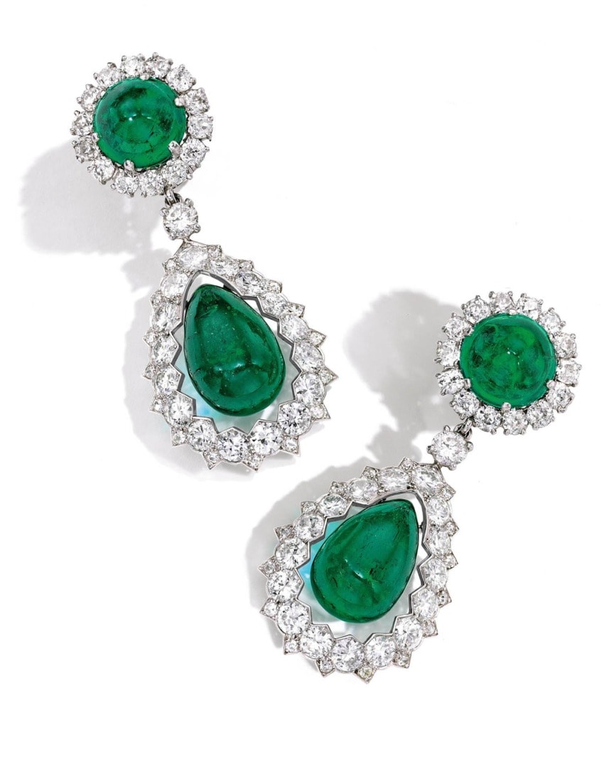 Elegant drop earrings with vibrant green gemstones surrounded by sparkling white diamonds.