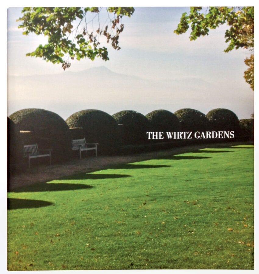 Cover of "The Wirtz Gardens" book showing a lush green garden with benches and trimmed hedges under a sunny sky.