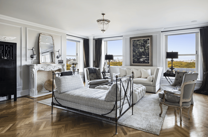 Luxurious living room with elegant decor, featuring a chandelier, large windows, and a sophisticated seating area.