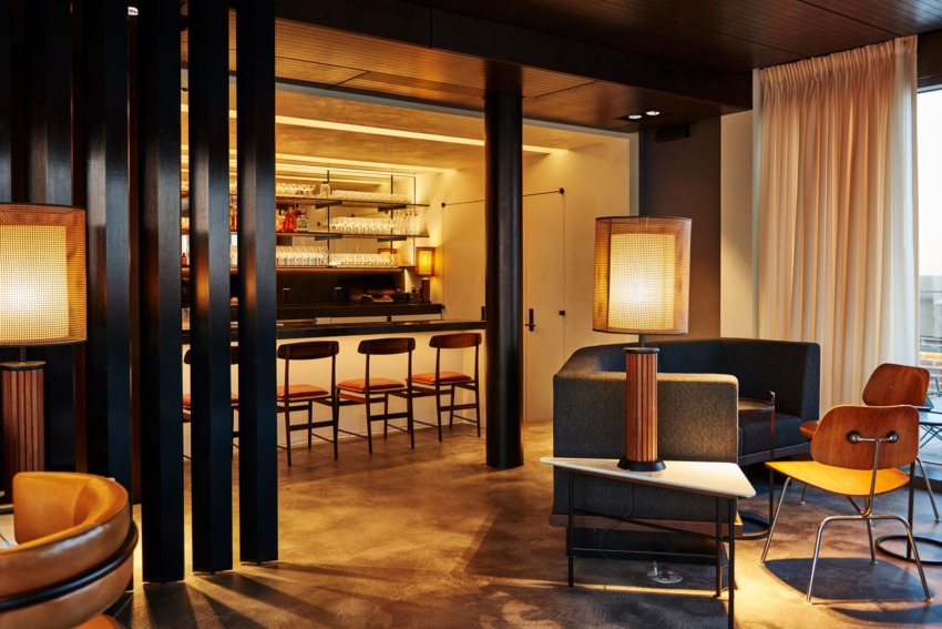 Stylish modern hotel lounge with bar, cozy seating, and warm lighting ambiance