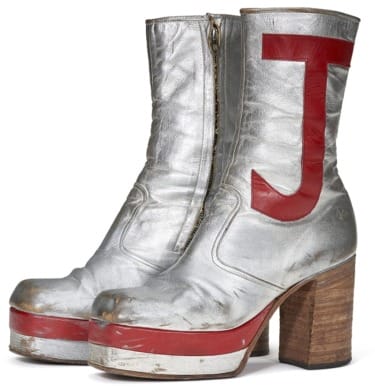Silver platform boots with red trim and letter "J" on the sides, featuring wooden heels and side zippers.