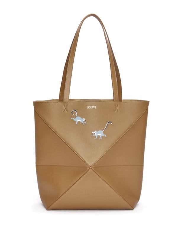 Brown leather tote bag with geometric design and two small embroidered animals on the front.
