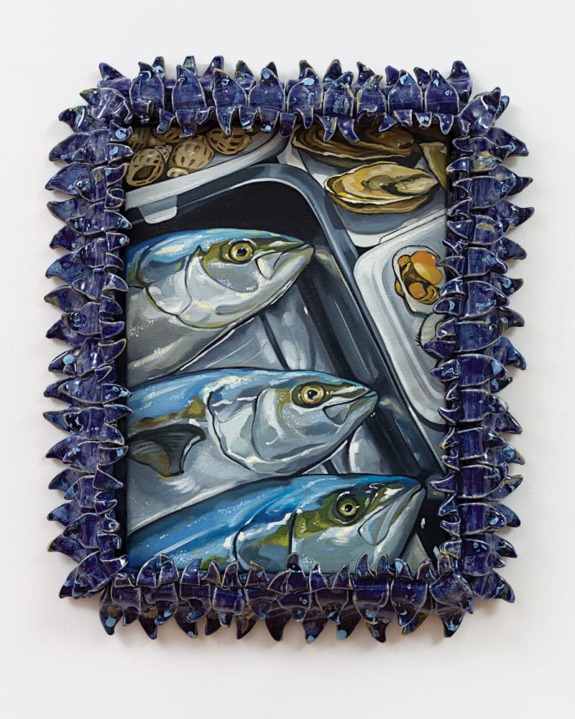 Painting of fish on a tray surrounded by a decorative fish-shaped frame.