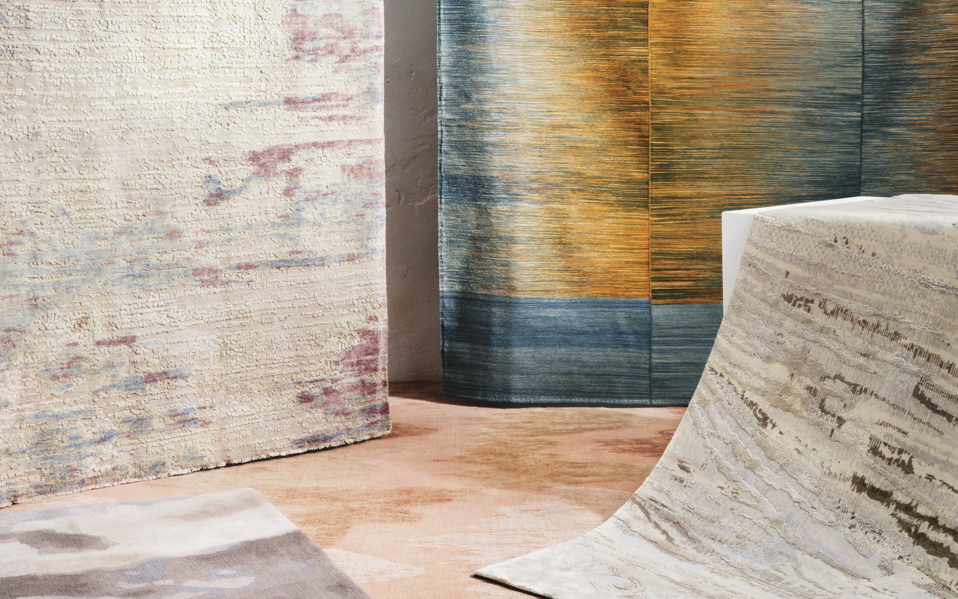 luxurious modern rugs in various colors and textures displayed in a showroom setting