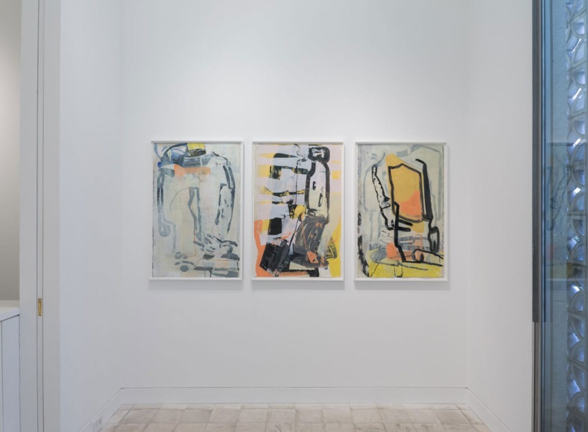 Three abstract paintings on a white gallery wall, featuring bold brushstrokes in blue, yellow, and black tones.