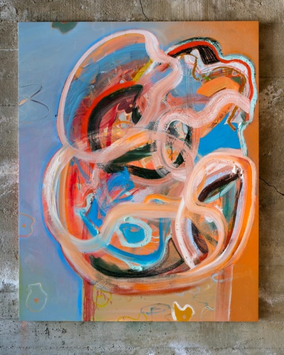 Abstract painting with vibrant swirls and patterns on a textured wall background.