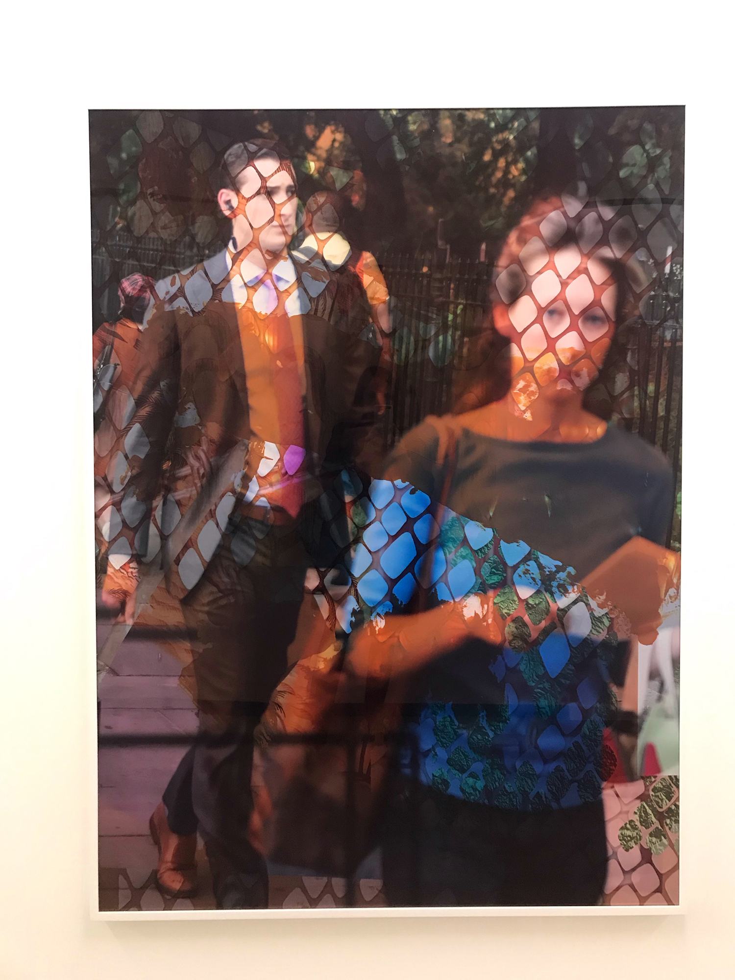 Abstract art piece featuring two blurred individuals with intricate patterns overlaying the image, creating a dynamic visual effect.