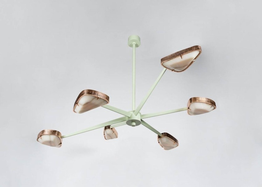 Modern ceiling chandelier with six arms and copper-accented lampshades against a neutral background.