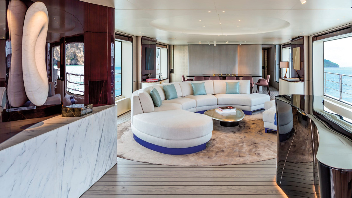 Luxury yacht interior with modern furnishings, plush white sofas, large windows with ocean view, and sophisticated decor.