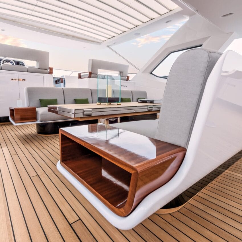 luxurious yacht deck with modern seating, wooden accents, and a glass lantern placed on a table, under a sunroof