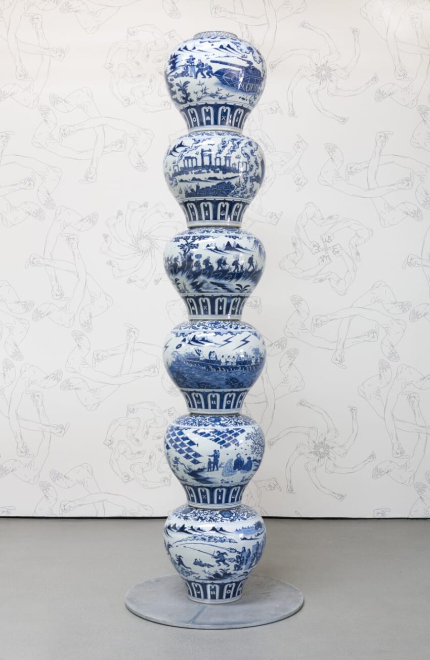 Tall stack of seven blue and white porcelain vases with various intricate designs against a sketched wall background.