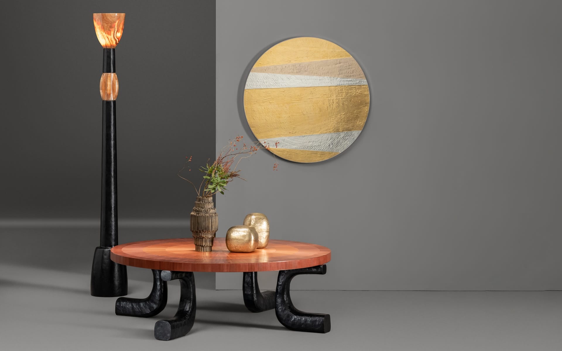 Modern living room with unique furniture featuring a round orange table, black floor lamp, and decorative wall mirror.