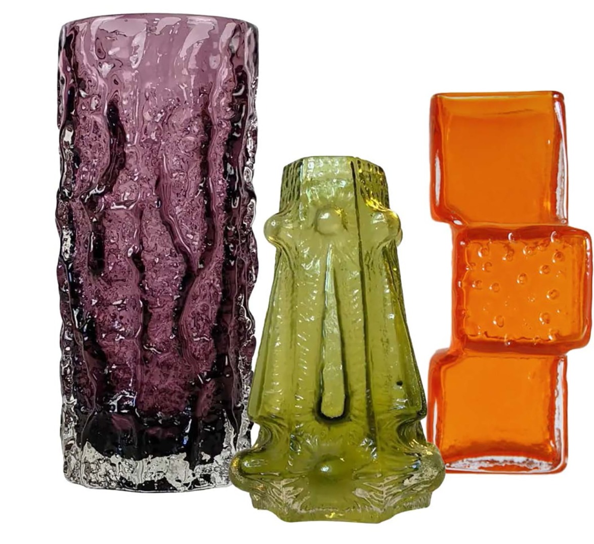Three colorful glass vases with unique textures: purple with bark texture, green with frilled design, orange with square pattern.