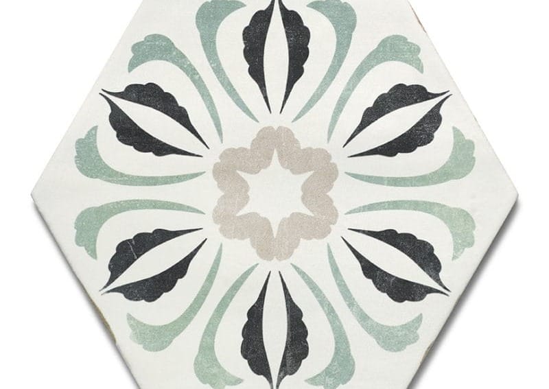 Hexagonal ceramic tile with a symmetrical floral pattern in black, gray, and green on a white background.