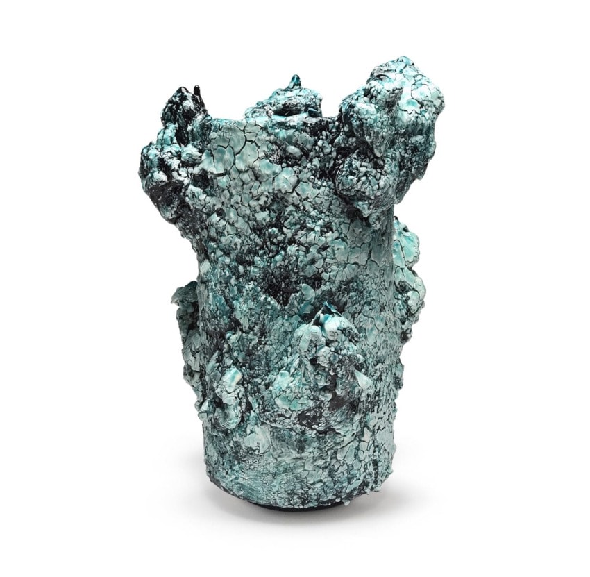 Sculptural green ceramic vase with textured, rough surface and abstract form.