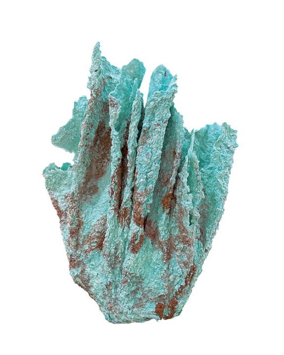 Turquoise-green and brown mineral with jagged, layered formations, resembling a crystalline structure, set against a white background.
