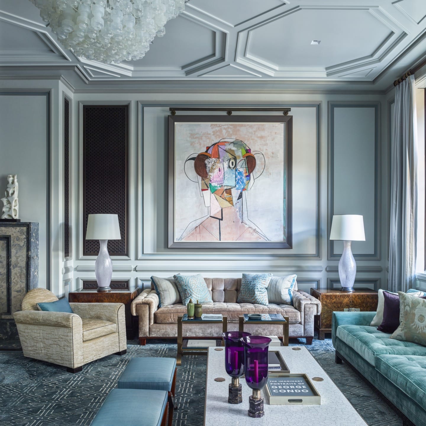 Luxurious living room with modern art, elegant furniture, plush sofas, large painting, and natural light from tall windows.