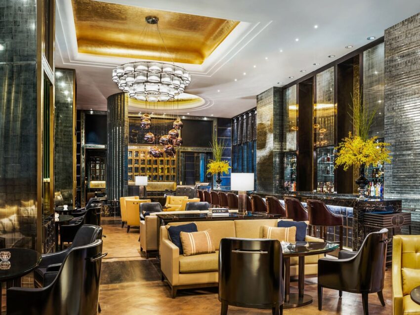 Luxurious modern hotel lounge with elegant seating, stylish decor, and ambient lighting.