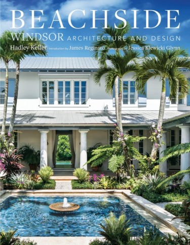 Tropical mansion exterior with palm trees and a fountain in a luxurious garden setting under a clear blue sky.
