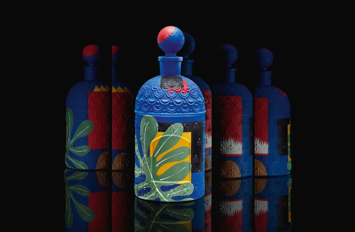 Colorful perfume bottles with vibrant geometric and floral designs against a black background.