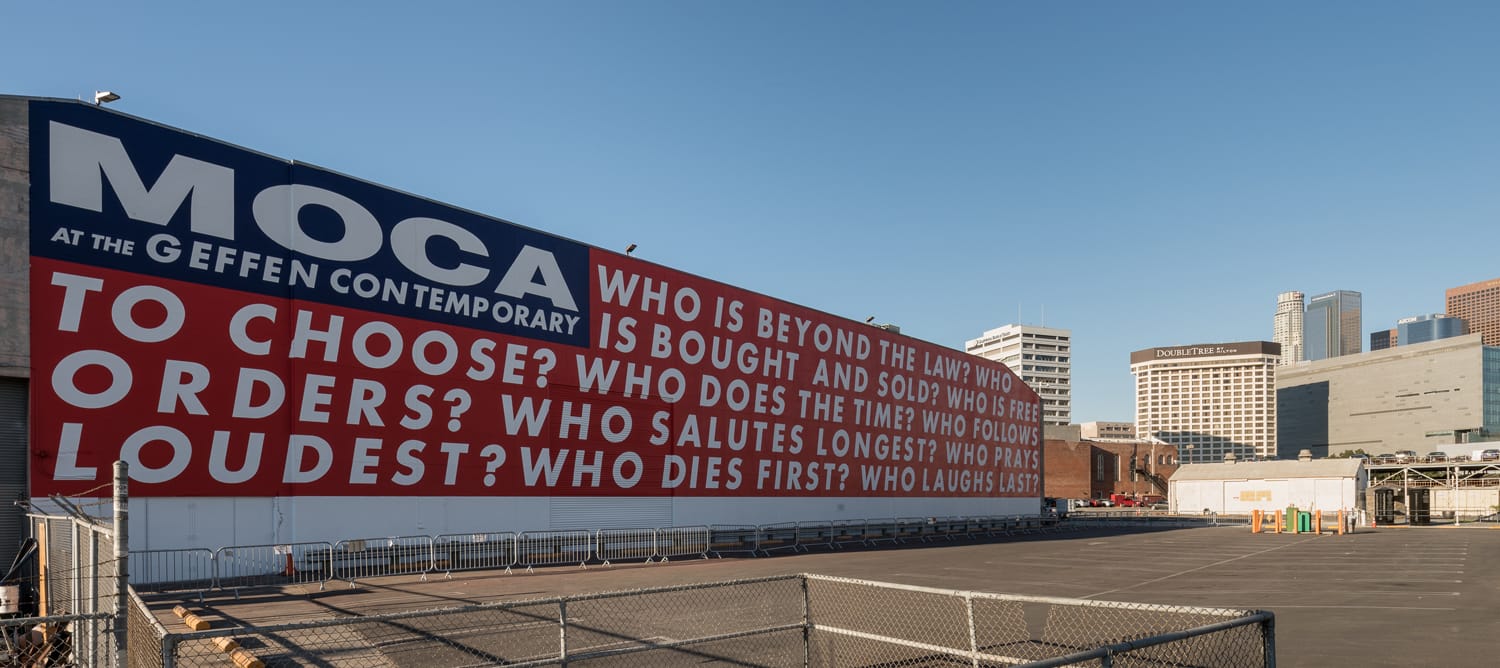 Large mural with thought-provoking questions covers the side of the MOCA building at the Geffen Contemporary in Los Angeles.