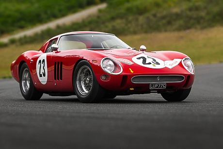 Red vintage sports car with number 23 on the track.