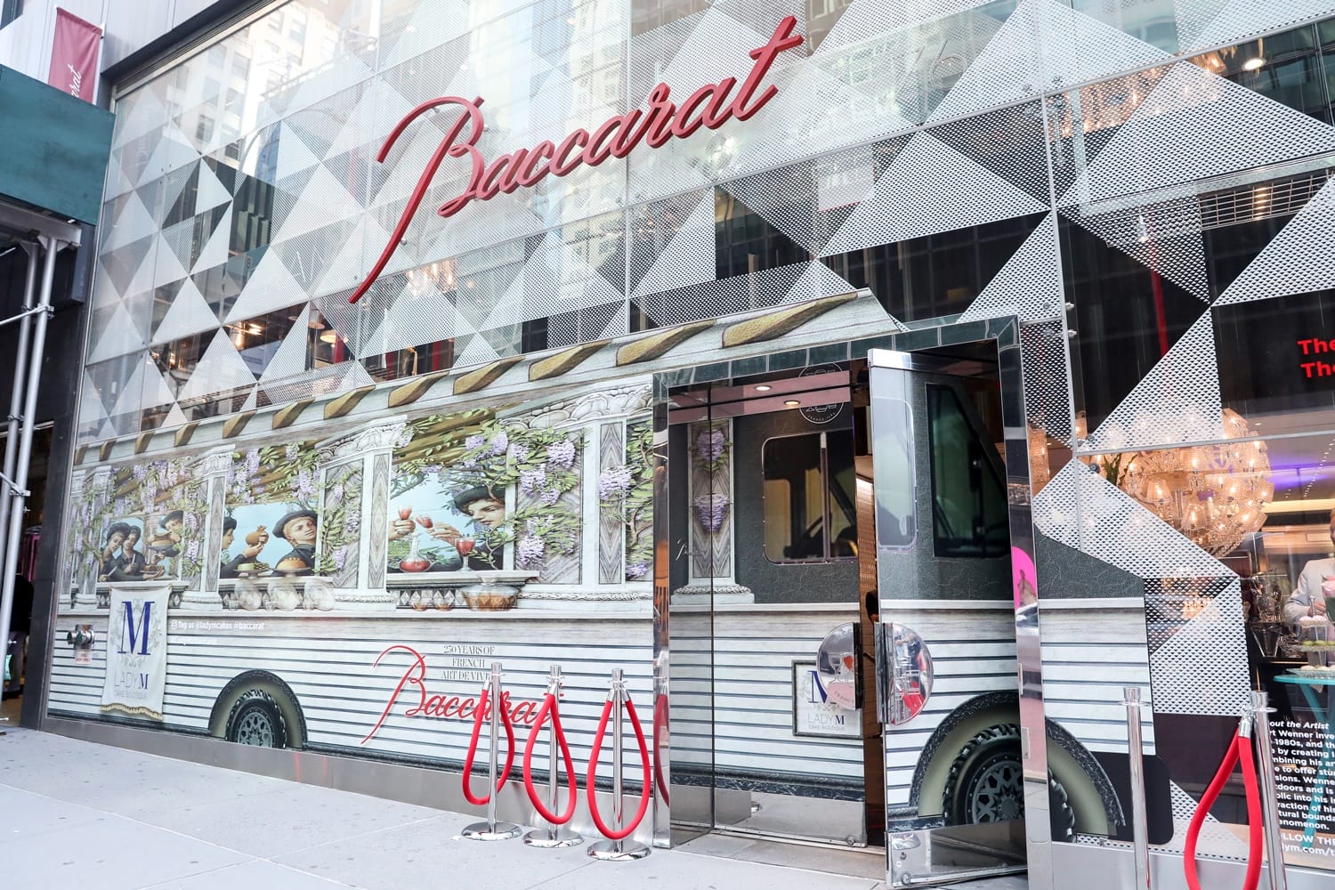 Storefront with a decorative facade resembling a food truck, featuring vibrant images of food and people.