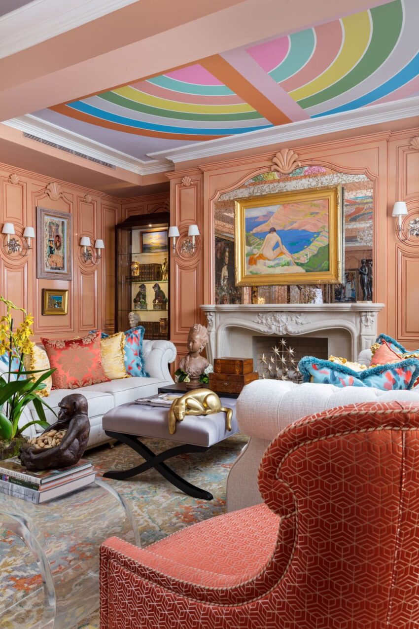 Eclectic living room with colorful ceiling, artworks, and vibrant decor on a mix of classic and modern furniture.