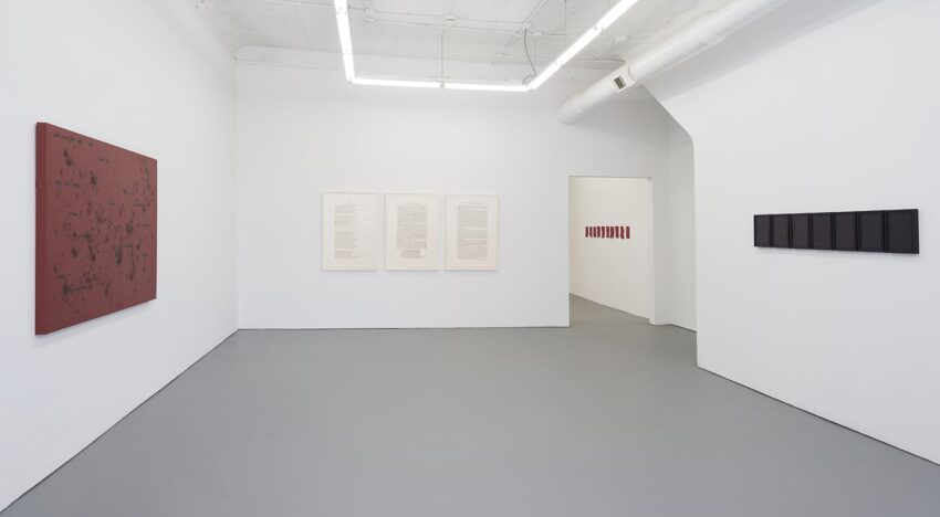 art gallery interior with minimalist artworks displayed on white walls and a gray floor