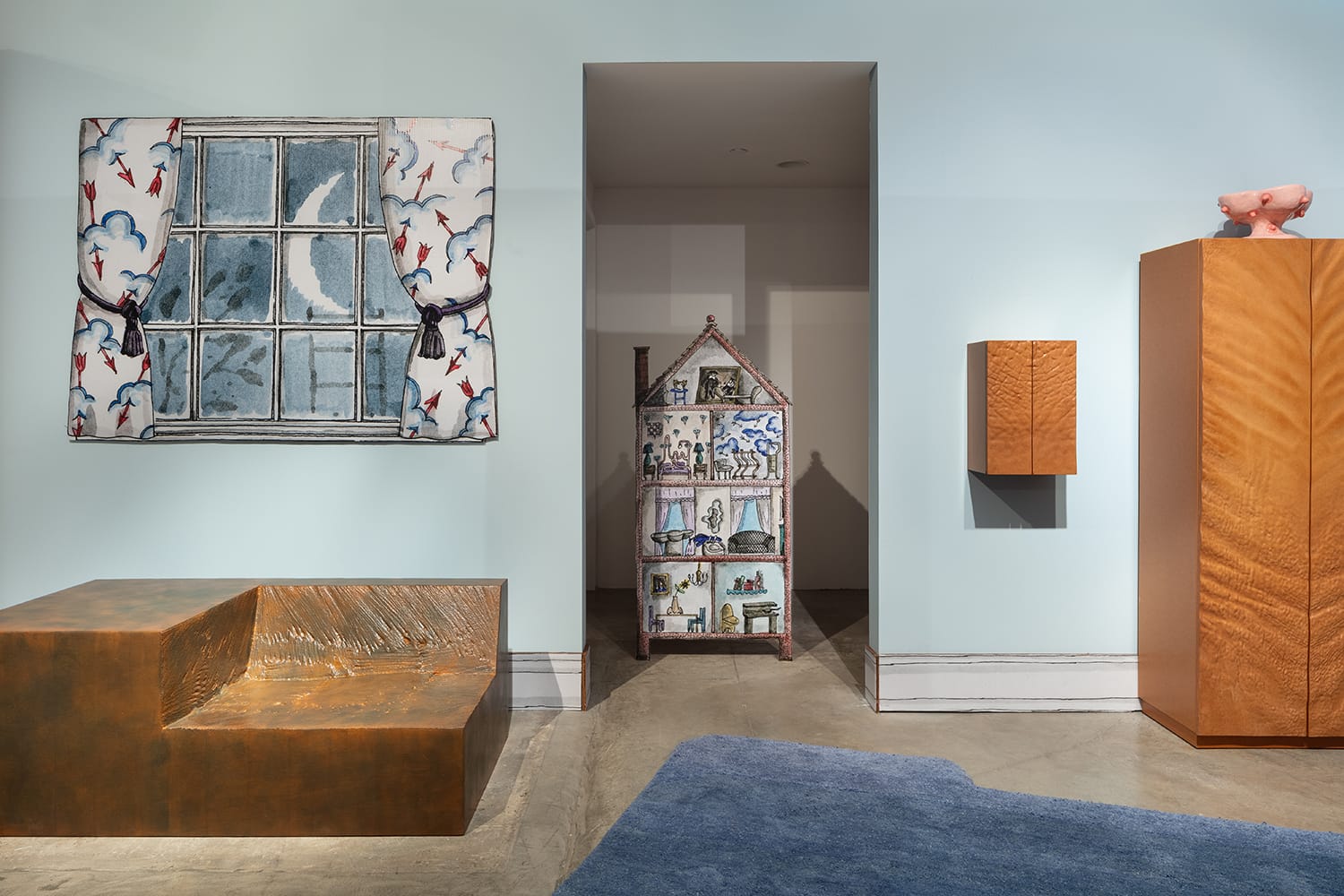 Modern art exhibit with eclectic furniture pieces, wall art, and unique installation in a minimalist gallery setting.