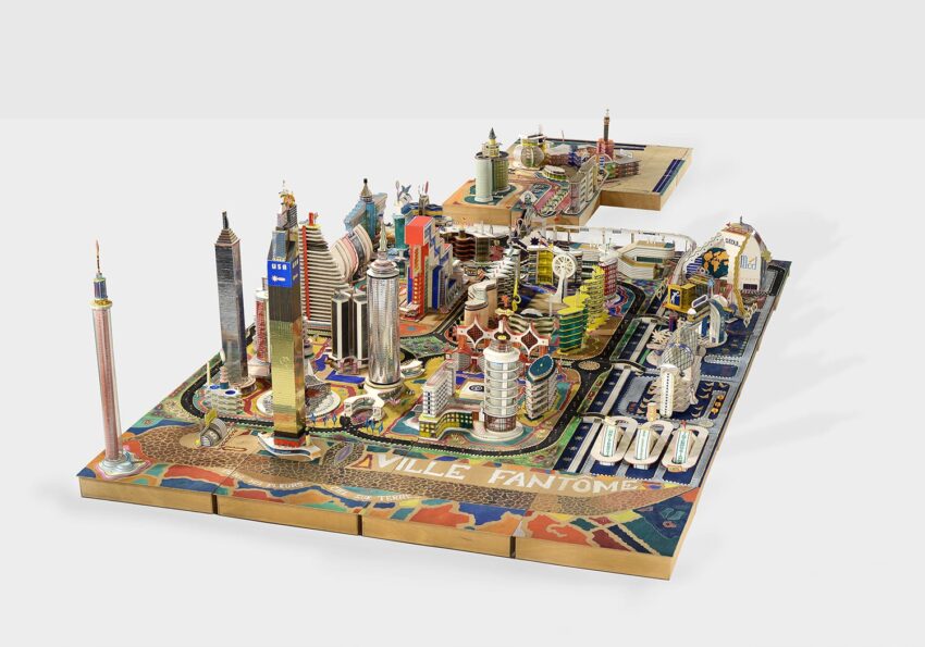 Model of a futuristic cityscape with colorful, intricate buildings and structures on a patterned base.