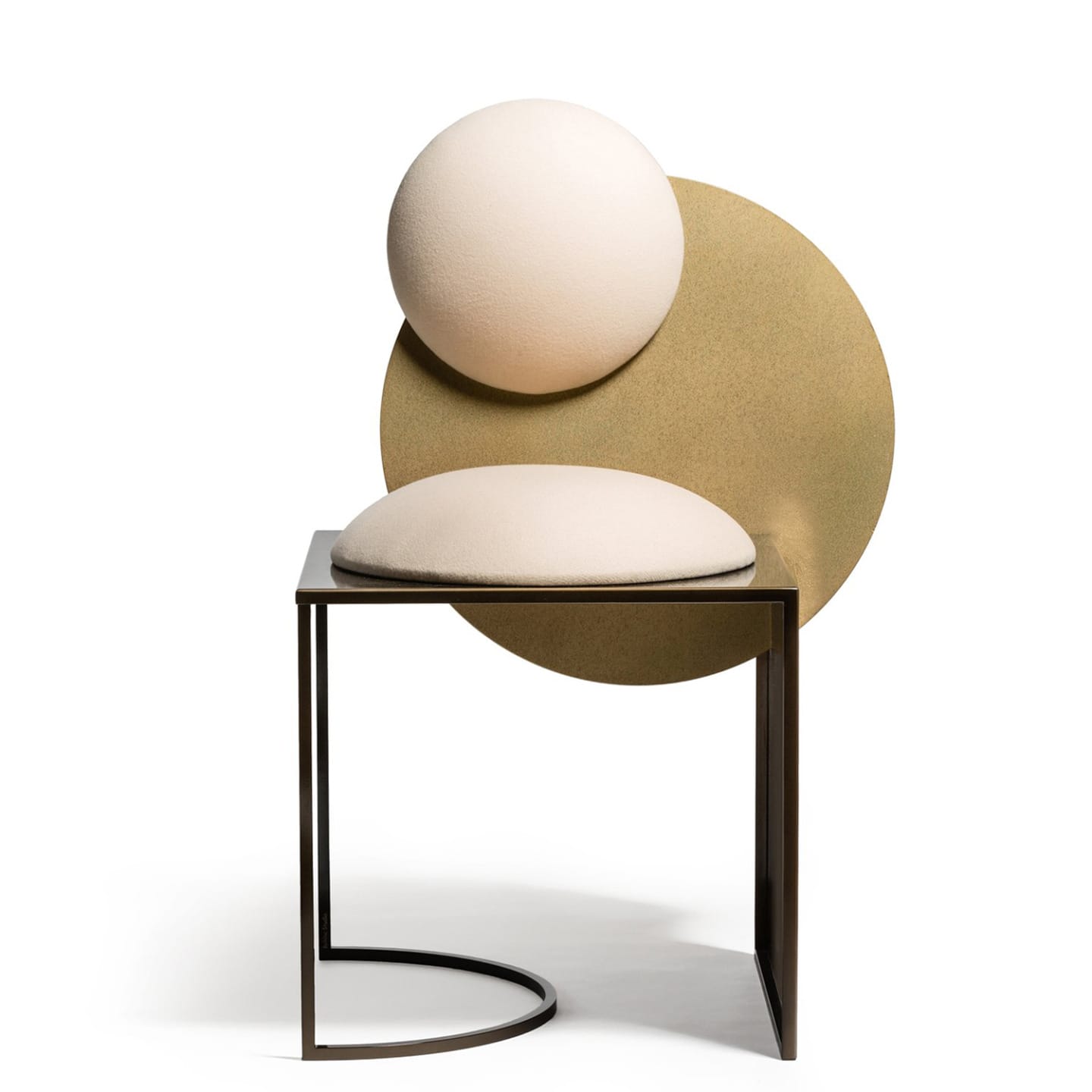 Modern artistic chair with round cushions and a geometric design, featuring metal and fabric elements in neutral tones.