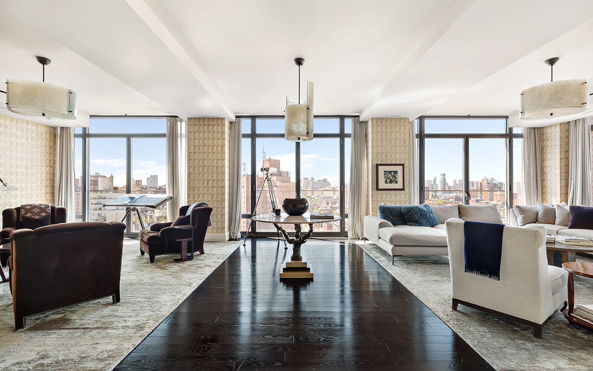 Luxurious living room with modern furniture, large windows, and city view. Black wooden floor and stylish decor.
