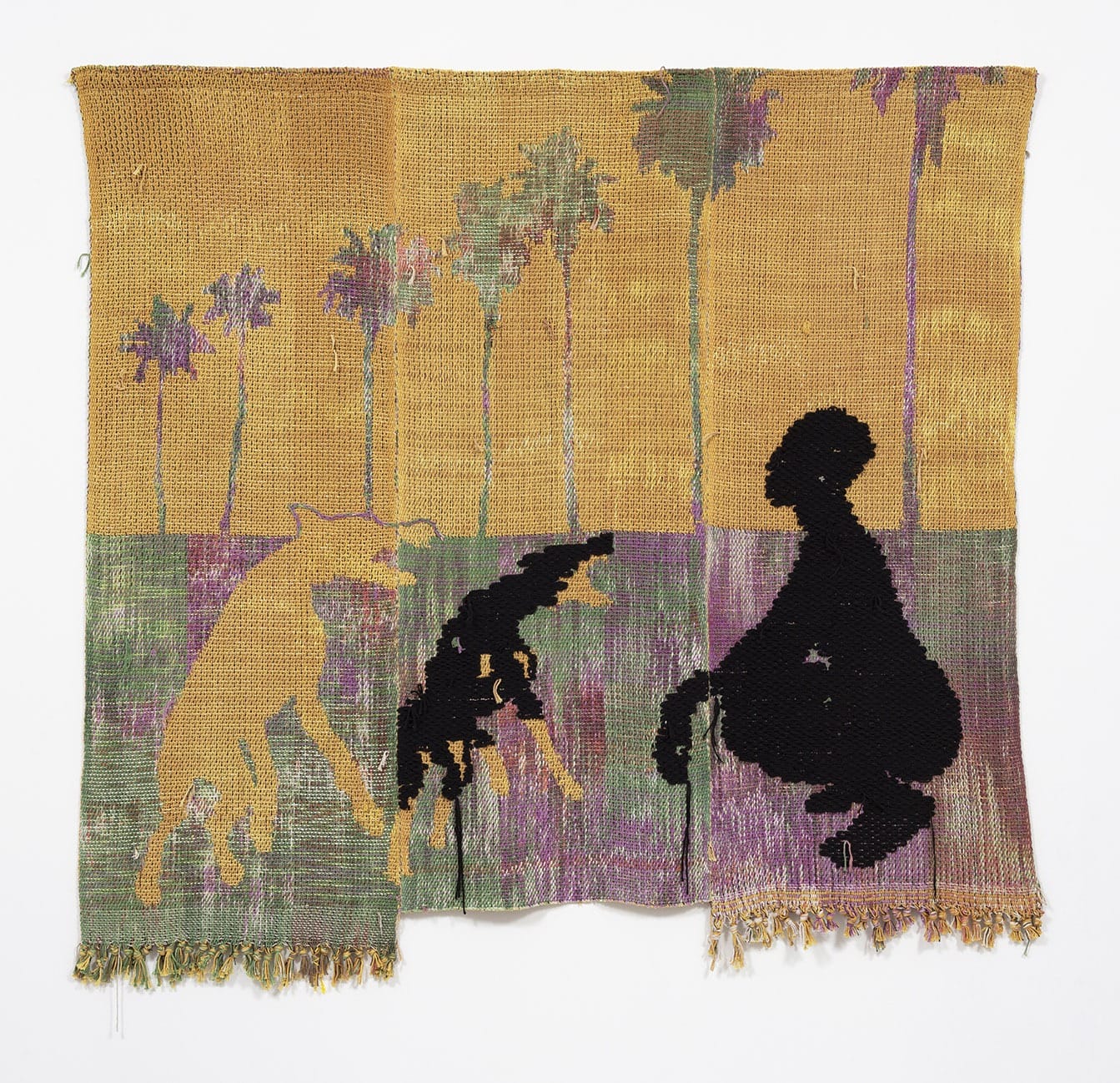 Woven tapestry featuring silhouettes of a person and two dogs against a backdrop of palm trees and a warm sky.