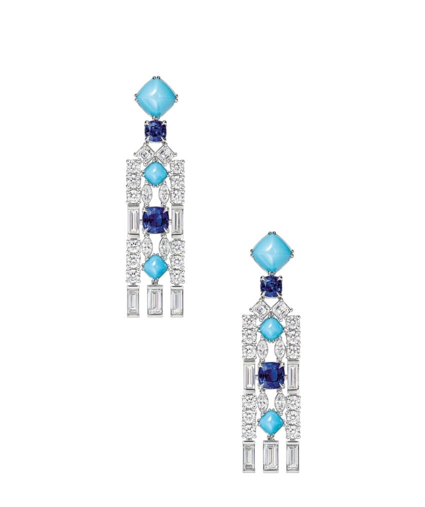 Elegant dangling earrings with blue stones, diamonds, and geometric design on a white background.