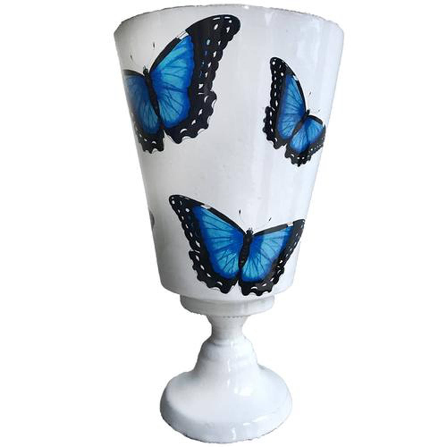 White vase with blue butterfly designs on a pedestal base.