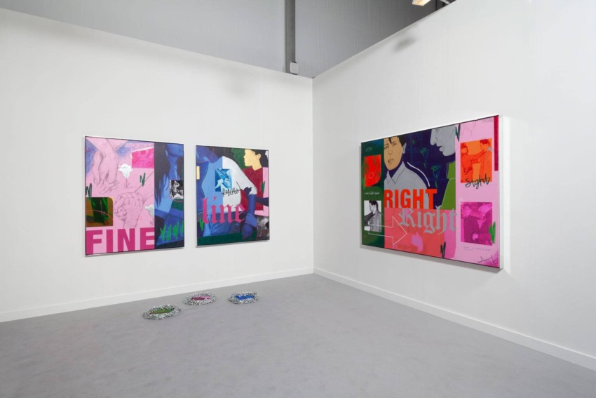 Contemporary art installation in a gallery with vibrant abstract paintings on white walls.