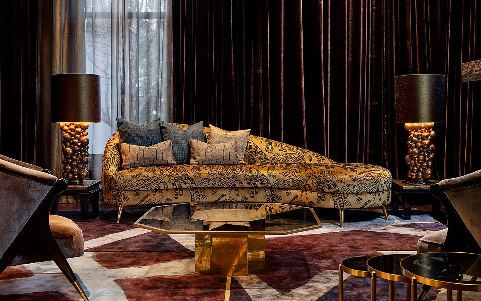 Luxurious living room with patterned chaise lounge, velvet curtains, modern lamps, and geometric rugs.
