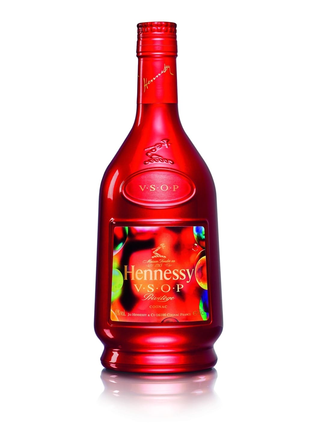 Red Hennessy V.S.O.P Privilege cognac bottle with vibrant reflections and elegant design.