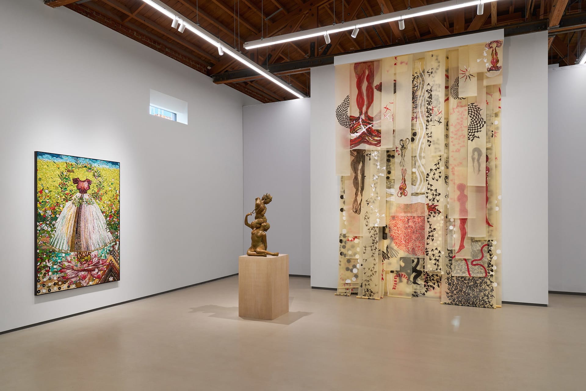 Art gallery showcasing a floral painting, bronze sculpture on a pedestal, and a large abstract wall tapestry.