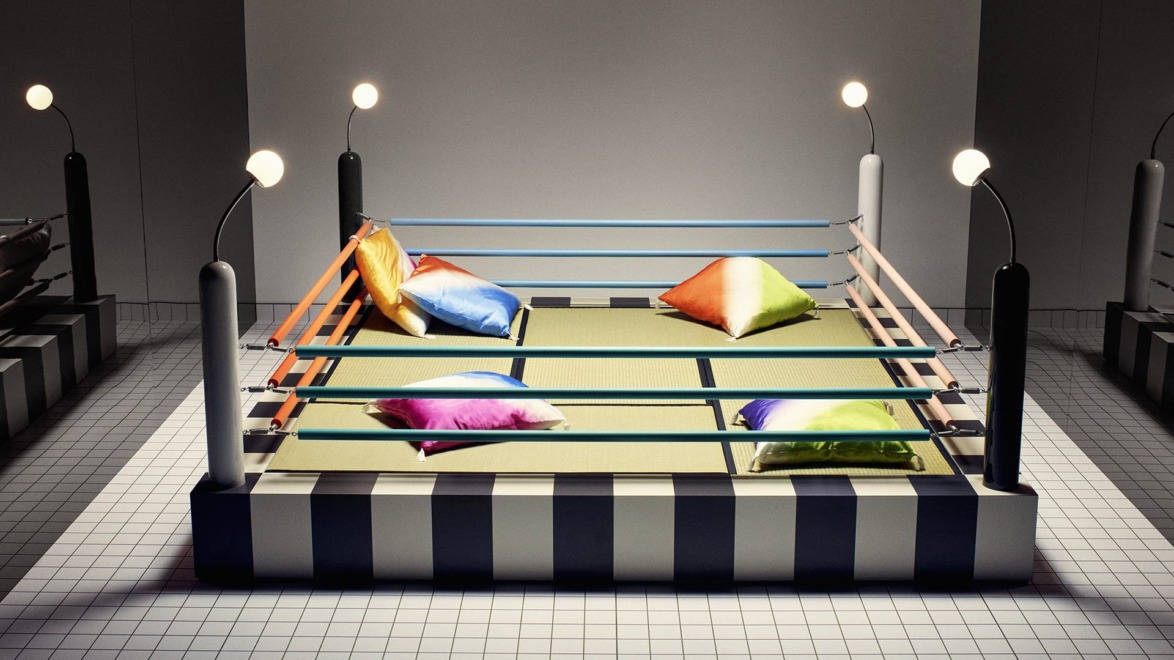 Colorful pillows in a boxing ring set on a tiled floor with modern lighting.