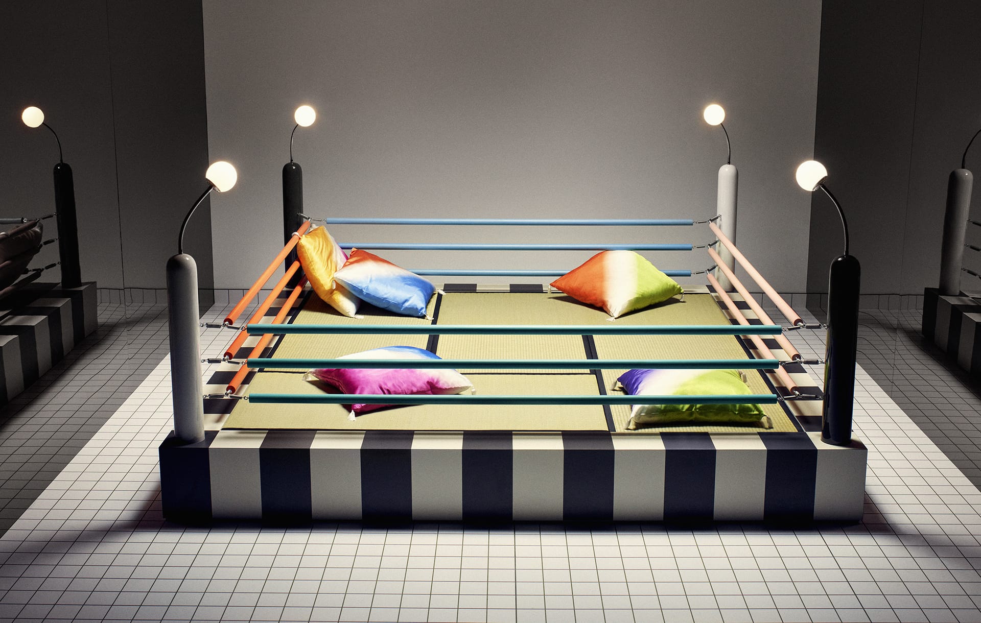 Colorful pillows in a boxing ring set on a tiled floor with modern lighting.