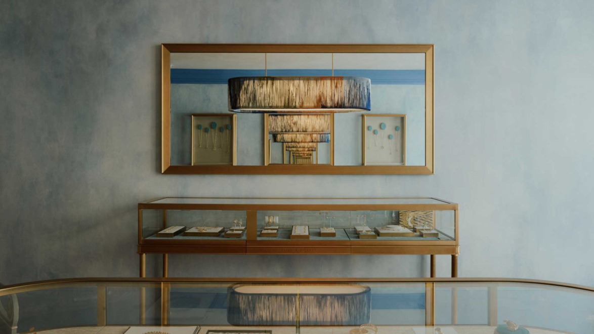 Luxury boutique interior with elegant display cases, modern lighting, and framed art on the walls, creating a sophisticated ambiance.