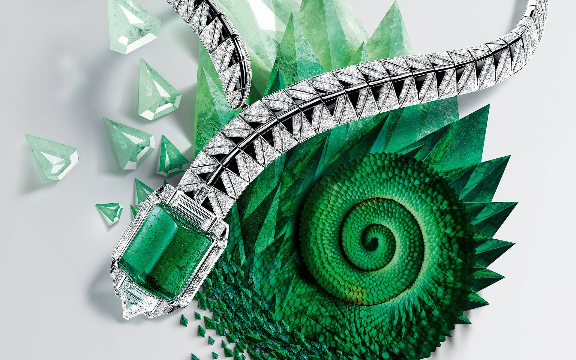 Silver and emerald necklace on a green spiral pattern background.