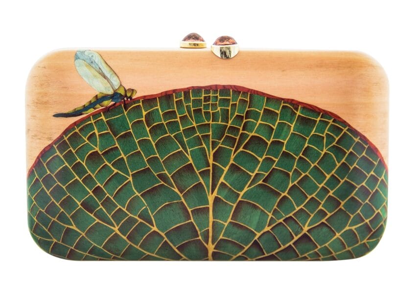 Handcrafted wooden clutch with a green leaf pattern and a dragonfly design on the front.