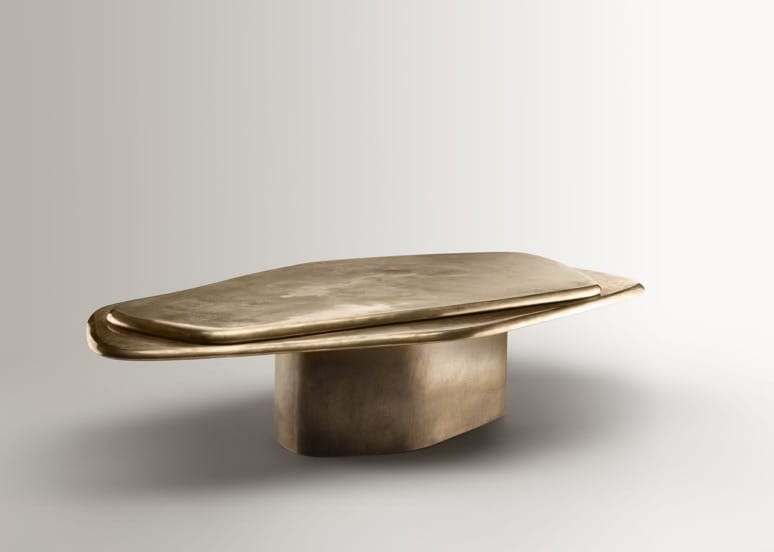 Modern bronze abstract table sculpture with clean lines and a smooth surface on a neutral background.