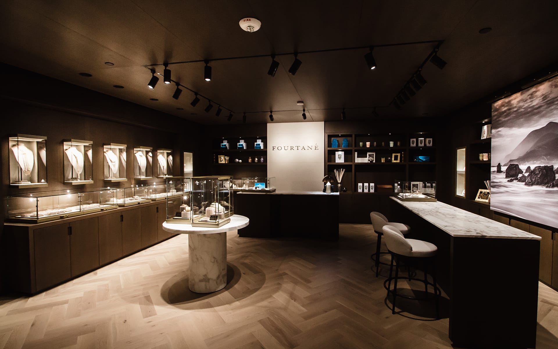 Luxury jewelry store interior with elegant display cases, modern lighting, and a marble countertop.