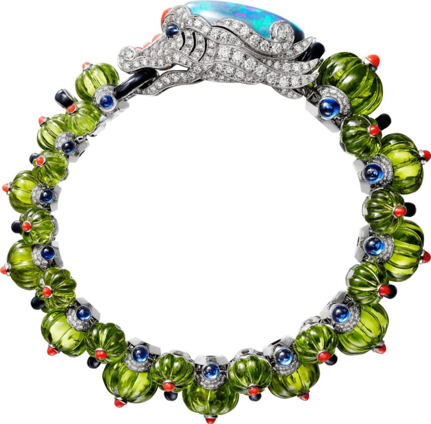 Dragon-themed bracelet with green stones, blue and red accents, and a jeweled dragon head clasp design.