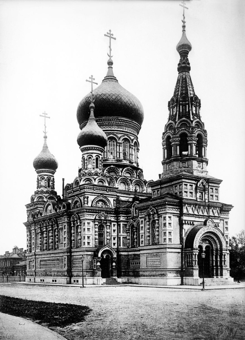 Historic black and white photo of a Russian Orthodox church with multiple domes and ornate architectural details.